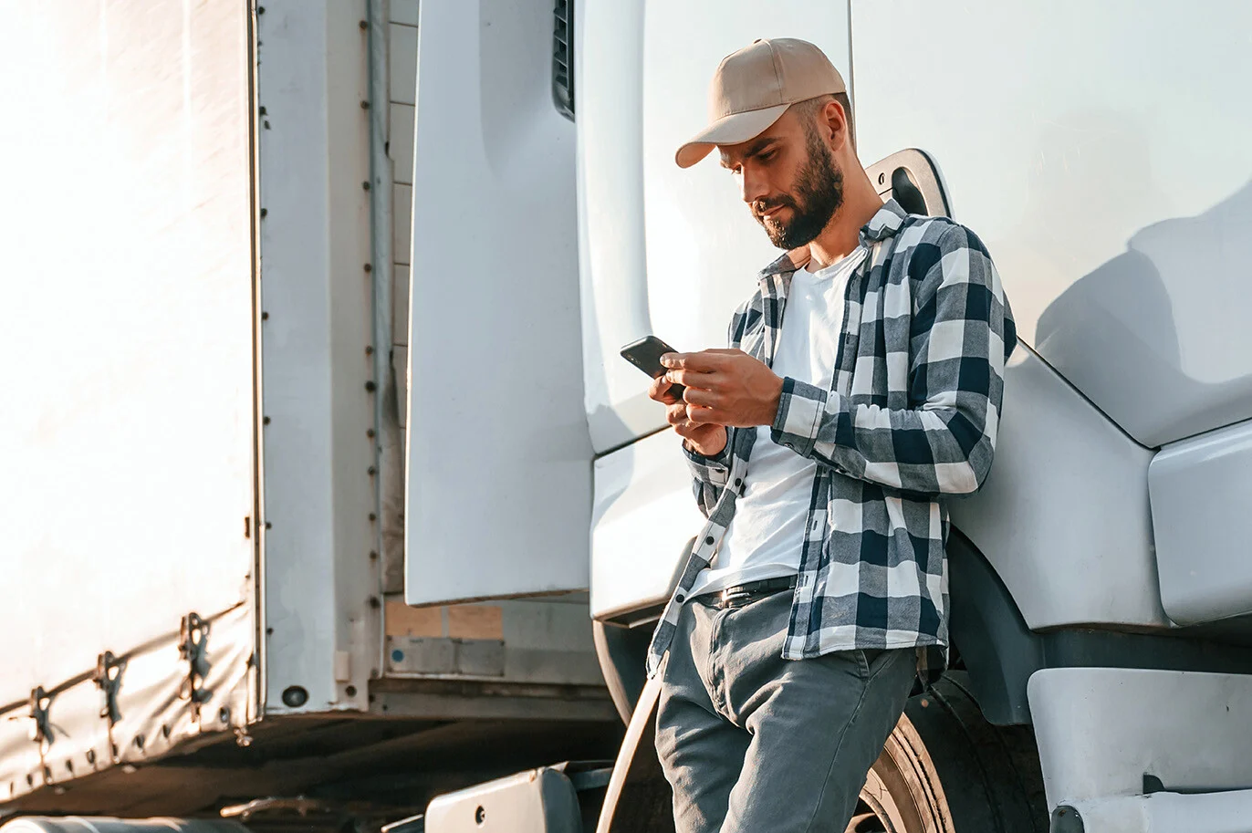 Owner-operator beside a freight truck